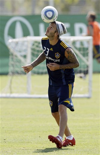 
 Los Angeles Galaxy's David Beckham heads soccer ball during an training session in Carson, Calif., Thursday, Sept. 23, 2010. Beckham's management company says it is taking legal action against a U.S. magazine that published claims the former England captain slept with prostitutes. The company says in a statement the allegations in the weekly In Touch are 'completely untrue and totally ridiculous as the magazine was clearly told before publication.' (AP Photo/Reed Saxon)
 