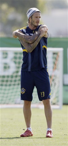 
 Los Angeles Galaxy's David Beckham looks on during a soccer training session in Carson, Calif., Thursday, Sept. 23, 2010. Beckham's management company says it is taking legal action against a U.S. magazine that published claims the former England captain slept with prostitutes. The company says in a statement the allegations in the weekly In Touch are 'completely untrue and totally ridiculous as the magazine was clearly told before publication.' (AP Photo/Reed Saxon)
 