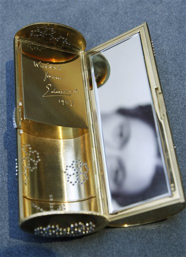 
 The interior, with an inscription 'Wallis from Edward 1947', of a Cartier gold and diamond necessaire du soir is seen on display at the auction house in London, Thursday, Sept. 23, 2010. The evening case, formerly in the collection of the Duchess of Windsor, was seen with the Duchess at a reception she and the Duke attended on the inviation of President Richard Nixon in 1970 is to be auctioned in 'The Jewels of the Duchess of Windsor' sale on Nov. 30 with an estimated price of 50,000 to 70,000 pounds (US$78,320 to 109,649 or 58,779 to 82,291 euro). (AP Photo/Sang Tan)
 