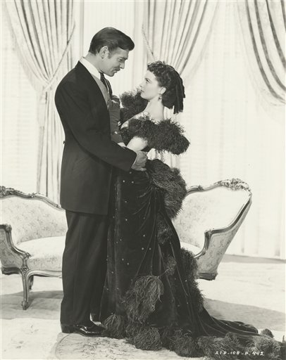 
 FILE - This 1939 photo provided Aug. 10, 2010, by the Harry Ransom Center at the University of Texas in Austin shows Vivien Leigh, as Scarlett O'Hara, wearing a burgundy ball gown, and co-star Clark Gable in Gone With The Wind. Ransom Center officials announced Tuesday, Aug. 31, 2010, they had met their $30,000 fundraising goal to pay for restoring five of Scarlett O'Hara's gowns for an exhibit to mark the 1939 movie's 75th anniversary in 2014. The center said contributions came from more than 600 people in 44 states and 13 countries. (AP Photo/The Harry Ransom Center at the University of Texas in Austin) NO SALES
 
