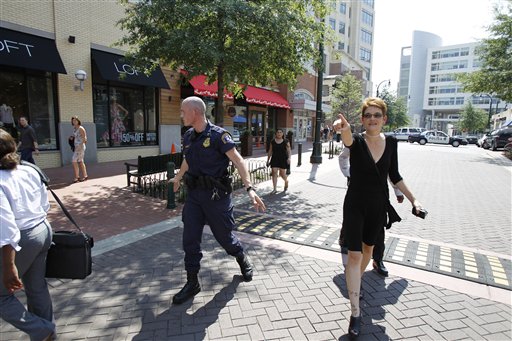 
 Police evacuate the street in Silver Spring plaza in front of the headquarters of the Discovery Channel networks building in Silver Spring, Md., Wednesday Sept. 1, 2010. Police say a gunman has taken at least one person hostage in the building. (AP Photo/Jose Luis Magana)
 