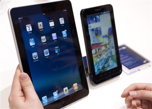 
 A journalist compares the new Samsung Galaxy Tab, right, a tablet computer to compete with the Apple iPad, left, at IFA, the world's largest trade fair for consumer electronics and electrical home appliances, in Berlin, Germany, Thursday, Sept. 2, 2010. IFA takes place from Sept. 3 to Sept. 8, 2010 on the Berlin Exhibition Grounds. (AP Photo/Gero Breloer)
 