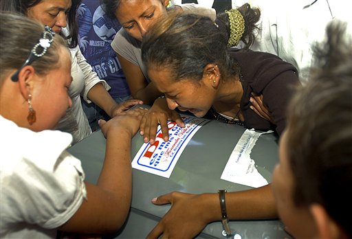 
 Relatives react over the coffin of one of 16 Hondurans who were killed in Mexico while trying to reach the US border after their bodies were repatriated to Tegucigalpa, Honduras, Wednesday Sept. 1, 2010. The bodies of 72 Central and South American migrants, who were allegedly killed by a Mexican drug cartel, were found within 100 miles of the U.S. border on Aug. 24. (AP Photo/Fernando Antonio)
 