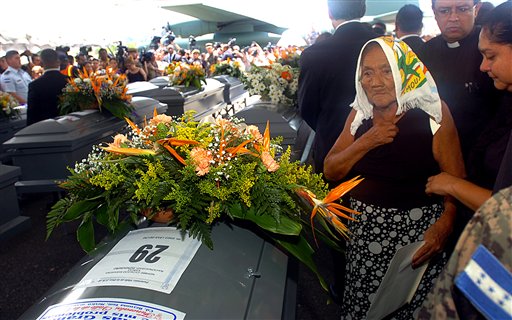 
 Relatives gather around the coffins of 16 Hondurans who were killed in Mexico while trying to reach the US border after their bodies were repatriated to Tegucigalpa, Honduras, Wednesday Sept. 1, 2010. The bodies of 72 Central and South American migrants, who were allegedly killed by a Mexican drug cartel, were found within 100 miles of the U.S. border on Aug. 24. (AP Photo/Fernando Antonio)
 
