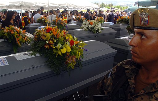
 A soldier stands by the coffins of 16 Hondurans who were killed in Mexico while trying to reach the U.S. border, after the bodies were repatriated to Tegucigalpa, Honduras, Wednesday Sept. 1, 2010. The bodies of 72 Central and South American migrants, who were allegedly killed by a Mexican drug cartel, were found within 100 miles of the U.S. border on Aug. 24. (AP Photo/Fernando Antonio)
 