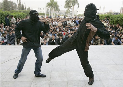 
 In this Dec.10, 2006 picture masked Egyptian Muslim Brotherhood students perform a military show inside their al-Azhar university campus in Cairo, Egypt. Centered on a 2009 court case in which the Brotherhood was accused of setting up a student militia, a TV miniseries airing in Egypt that casts a harsh light on the country's largest opposition movement, the Muslim Brotherhood, plot weaves through in flashbacks decades long confrontations between Egypt's various governments and the group. Arabic on their masks read 'We're holding on'. (AP Photo)
 
