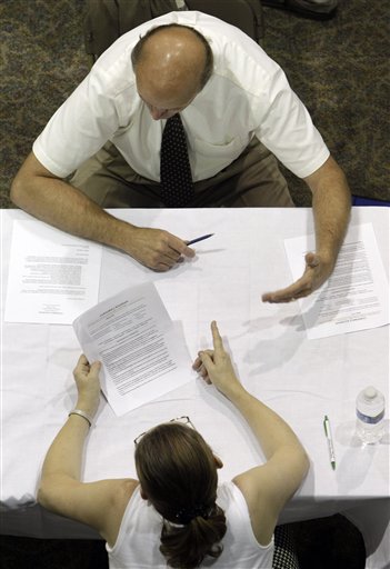 
 In this Aug. 25, 2010 photograph, Clifford Iglodan, top, receives advice on his resume while attending a job fair in Southfield, Mich. (AP Photo/Paul Sancya)
 