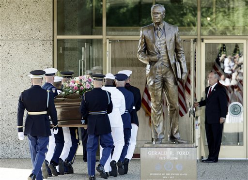 
 A military honor guard carries the casket bearing the body of former first lady Betty Ford as they passes a statue of the former President at Gerald R. Ford Presidential Museum Wednesday, July 13, 2011 in Grand Rapids, Mich. The former first lady will be buried at the museum on Thursday next to her husband. (AP Photo/M. Spencer Green)
 
