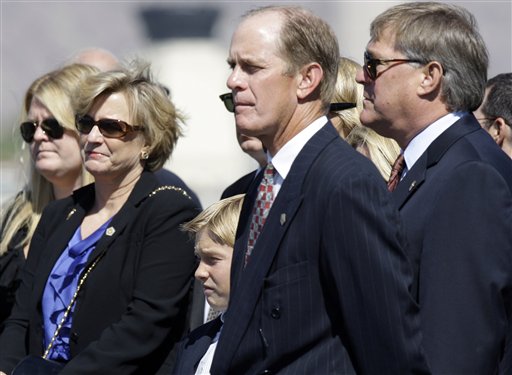 
 From second left, Susan Ford Bales, Michael Ford and Jack Ford watch as a military honor guard transfers the casket of their mother, former first lady Betty Ford, to a U.S. Air Force C-32 for a flight to Grand Rapids, Mich., at Palm Springs International Airport in Palm Springs, Calif., Wednesday, July 13, 2011. Ford will be buried in Michigan on Thursday next to her husband former President Gerald R. Ford. (AP Photo/Reed Saxon)
 