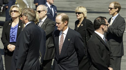 
 From left, Susan Ford Bales, Jack Ford, Michael Ford, center, and Steve Ford, far right, watch as a military honor guard transfers the casket of their mother, former first lady Betty Ford, to a U.S. Air Force C-32 for a flight to Grand Rapids, Mich., at Palm Springs International Airport in Palm Springs, Calif., Wednesday, July 13, 2011. Ford will be buried in Michigan on Thursday next to her husband former President Gerald R. Ford. (AP Photo/Reed Saxon)
 