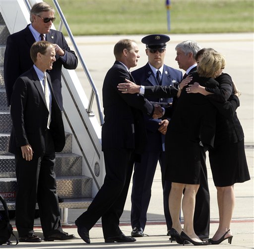 
 Susan Ford Bales, right, hugs Sue Snyder as Michigan Gov. Rick Snyder, third from right, shakes hands with Michael Ford as Steve Ford, bottom at left, and Jack Ford, top at left, exit the plane carrying the casket of former first lady Betty Ford at Gerald R. Ford International Airport in Cascade Township, Mich., Wednesday, July, 13, 2011. Ford will be buried in Grand Rapids, Mich., on Thursday next to her husband, former President Gerald R. Ford. (AP Photo/Paul Sancya)
 