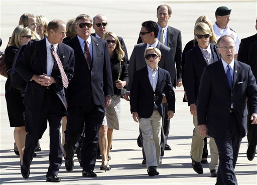 
 Members of the Ford family, including Steve Ford, left, and Jack Ford, second from left, arrive with the casket of former first lady Betty Ford at Gerald R. Ford International Airport in Cascade Township, Mich., Wednesday, July, 13, 2011. Ford will be buried in Grand Rapids, Mich., on Thursday next to her husband, former President Gerald R. Ford. (AP Photo/Paul Sancya)
 