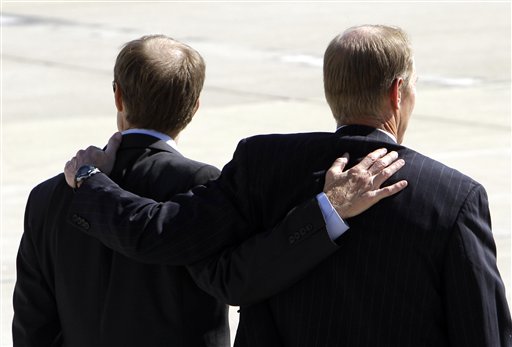
 Steve Ford, left, and Michael Ford watch as a military honor guard carry the casket of former first lady Betty Ford upon arrival at Gerald R. Ford International Airport in Cascade Township, Mich., Wednesday, July, 13, 2011. Ford will be buried in Grand Rapids, Mich., on Thursday next to her husband, former President Gerald R. Ford. (AP Photo/Paul Sancya)
 