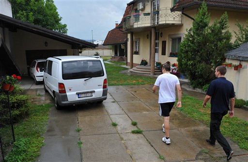 
 Goran Hadzic's son Srecko Hadzic in white t-shirt arrives at the house where Goran Hadzic used to live before he went into hiding in 2004, in Novi Sad, Serbia, Wednesday, July 20, 2011. Serbian authorities tracked down war crimes fugitive Goran Hadzic in the northern mountains Wednesday, arresting the last remaining fugitive sought by the U.N. war crimes court after eight years on the run. (AP Photo) SERBIA OUT
 