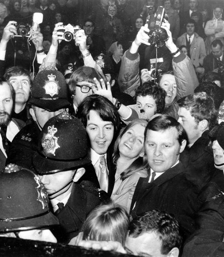 
 FILE- Newlyweds Paul McCartney, 26, and the American photographer formerly Linda Eastman, centre, are mobbed by a crowd of screaming fans as they are escorted by police, as the couple leave the Marylebone Town Hall Registry Office in London, after their wedding in this file photo dated March 12, 1969. According to news reports McCartney is to marry Nancy Shevell on Sunday Oct. 9, 2011, at the same location, Marylebone Town Hall, followed by a reception at his home in the St. John's Wood neighborhood of London. (AP Photo, file)
 