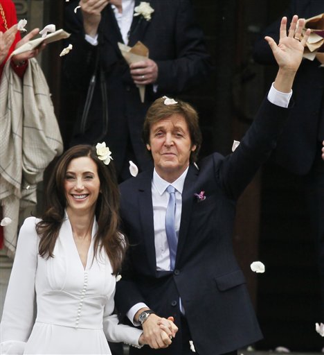 
 Former Beatle Paul McCartney and American heiress Nancy Shevell exit Marylebone Town Hall in central London following their wedding Sunday Oct 9 2011. Shevell, 51, is McCartney's third wife. They were engaged earlier this year. The couple met in the Hamptons in Long Island, New York, shortly after the singer's divorce from Heather Mills in 2008. (AP Photo/ Jim Ross)
 