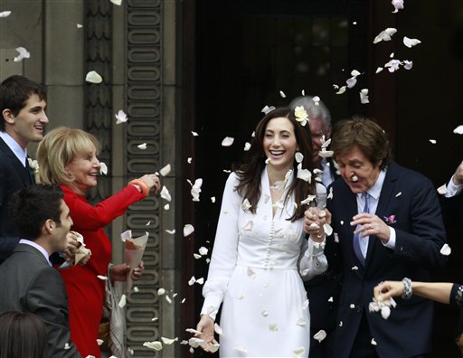 
 American broadcast journalist and author Barbara Walters throws rose petals as former Beatle Sir Paul McCartney and his wife American heiress Nancy Shevell leave Marylebone Registry Office, following their wedding in central London , Sunday Oct. 9, 2011. Shevell, 51, is McCartney's third wife.The couple met in the Hamptons in Long Island, New York, shortly after the singer's divorce from Heather Mills in 2008 and they were engaged earlier this year. (AP Photo/Lefteris Pitarakis)
 