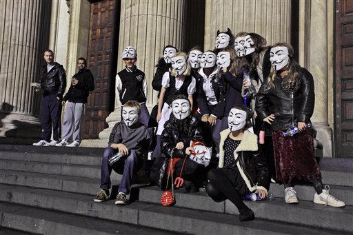 
 A masked group of London school friends aged eleven and twelve pose for photographs for the media beside the Occupy London Stock Exchange protest camp outside St Paul's Cathedral in London, Thursday, Oct. 27, 2011. The children walked past the protest camp after going to a party together where they wanted to dress up as 'mini-anons'. The plastic masks, which have been adopted by protesters in various countries around the world to keep their faces anonymous, represent Guy Fawkes, who attempted to blow up Britain's Houses of Parliament in the 1600s. (AP photo/Matt Dunham)
 