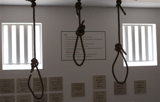 
 In this photo taken Thursday, Dec 8. 2011, nooses hang in the gallows at the Pretoria Central Prison. The government opened the gallows, in Pretoria, South Africa, Thursday, Dec. 15, as a monument to those who were executed before being stopped in 1989 and abolished in 1995. In background are plaques to those political prisoners who were executed. (AP Photo/Denis Farrell)
 