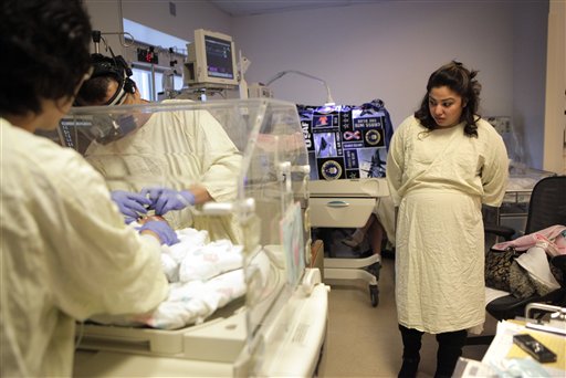 
 Haydee Ibarra, right, watches as her 14-week-old daughter, Melinda Star Guido, gets her eyes examined by ophthalmologist John Hwang at the Los Angeles County-USC Medical Center in Los Angeles, Wednesday, Dec. 14, 2011. At birth, Melinda Star Guido tipped the scales at only 9 1/2 ounces, a tad less than the weight of two iPhone 4S. Most babies her size don�t survive, but doctors are preparing to send her home as soon as the end of the month. Melinda is believed to be the second smallest baby to survive in the United States and the third smallest in the world. (AP Photo/Jae C. Hong)
 