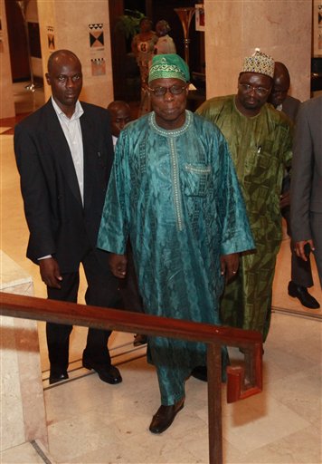 
 Former Nigerian President Olusegun Obasanjo, center, leaves his hotel for a meeting with incumbent Ivorian President Laurent Gbagbo, in Abidjan, Ivory Coast, Saturday, Jan. 8, 2011. Obasanjo made an unannounced visit to Ivory Coast late Saturday in an effort to help resolve the country's deepening political crisis after several other West African leaders have failed to persuade the incumbent to cede power.(AP Photo/Rebecca Blackwell)
 