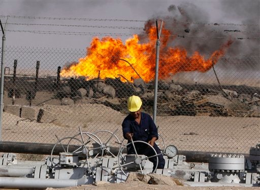 
 In this Dec. 13, 2009 file photo, an Iraqi worker operates valves at the Rumaila oil refinery, near the city of Basra, 550 kilometers (340 miles) southeast of Baghdad, Iraq. Iraq is hoping to rake in tens of billions of dollars from its oil sector. But it's not a matter of simply ramping up production from the fields _ it's how to deal with it once it starts flowing. Iraq's perennial security woes and a government still struggling to get its footing and direction all contribute to the uncertainty of how to these projects will move forward.(AP Photo/ Nabil al-Jurani, File)
 