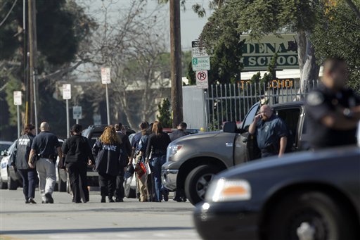 
 Investigators arrive at Gardena High School in Gardena, Calif., Tuesday, Jan. 18, 2011, after reports of a number of students being wounded during a shooting. (AP Photo/Jae C. Hong)
 