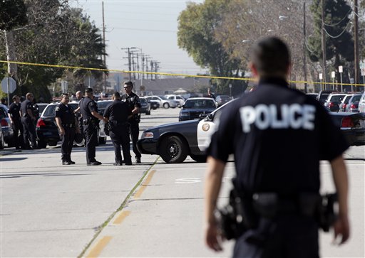 
 A group of police officers stand outside Gardena High School in Gardena, Calif., Tuesday, Jan. 18, 2011, after reports of a number of students being wounded during a shooting. (AP Photo/Jae C. Hong)
 