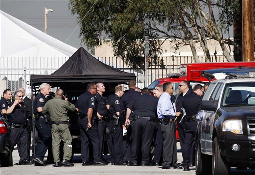 
 Members of the Los Angeles police department gather outside Gardena High School in Gardena, Calif., on Tuesday, Jan 18, 2011. According to officials, a number of students were wounded in a shooting at the high school. (AP Photo/Nick Ut)
 