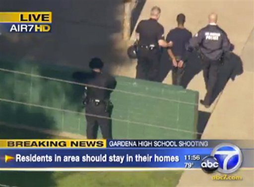 
 This frame grab from video made available by ABC7.com, shows a person being taken into custody at Gardena High School in Gardena, Calif. According to officials, a number of students were wounded in a shooting at the high school. (AP Photo/ABC7.com) MANDATORY CREDIT, NO SALES
 