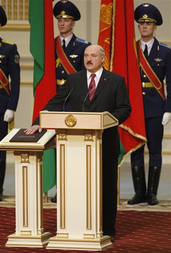 
 Belarusian President Alexander Lukashenko takes the presidential oath while placing his hand on the Belarusian Constitution, during an inauguration ceremony at the Palace of the Republic in Minsk, Belarus, Friday, Jan. 21, 2011. Lukashenko was sworn in for a fourth term. (AP Photo/Sergei Grits, Pool)
 