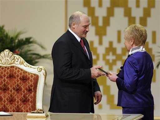 
 Central Elections Commission Chairwoman Lidiya Ermoshina, right, gives certificate of Presidency to Belarusian President Alexander Lukashenko during his inauguration ceremony at the Palace of the Republic in Minsk, Belarus, Friday, Jan. 21, 2011. Alexander Lukashenko was sworn in Friday for a fourth term. (AP Photo/Sergei Grits, Pool)
 