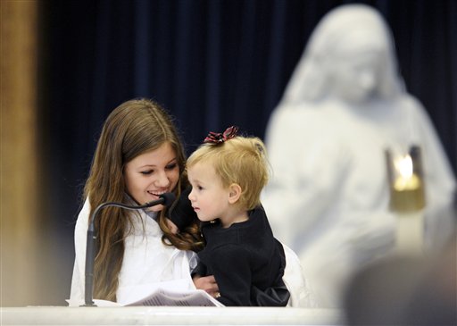 
 ** RETRANSMISSION TO ADD IDENTITY ** Two daughters of Robert 'Bobby' Shriver, Rosemary Scarlett Shriver, 2, in the arms of her sister Natasha Hunt Lee, speaks about her grandfather, R. Sargent Shriver, during a funeral Mass at Our Lady of Mercy Catholic church in Potomac, Md., Saturday, Jan. 22, 2011. Shriver, an in-law of the Kennedys, and the first director of the Peace Corps, died Tuesday. He was 95.(AP Photo/Cliff Owen, Pool)
 