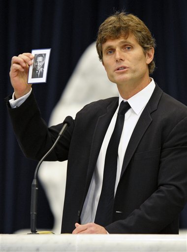 
 Anthony Shriver holds up a photograph of his father, R. Sargent Shriver, during his father's funeral Mass at Our Lady of Mercy Catholic church in Potomac, Md., just outside Washington Saturday, Jan. 22, 2011. Shriver, an in-law of the Kennedys, and the first director of the Peace Corps, died Tuesday. He was 95. (AP Photo/Cliff Owen, Pool)
 