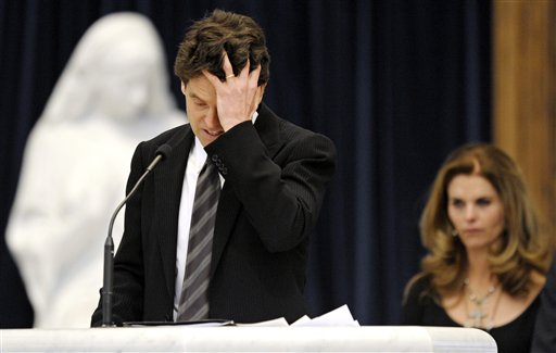 
 Mark Shriver holds his head while his sister Maria Shriver listens as he talks about their father, R. Sargent Shriver, during his funeral Mass at Our Lady of Mercy Catholic church in Potomac, Md., outside Washington, Saturday, Jan. 22, 2011. Shriver, an in-law of the Kennedys, and the first director of the Peace Corps, died Tuesday. He was 95.(AP Photo/Cliff Owen, Pool)
 