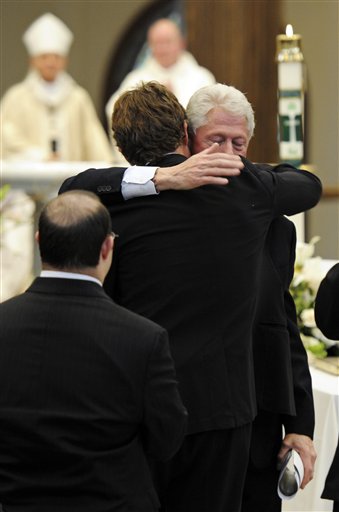 
 Former president Bill Clinton comforts Anthony Shriver during the funeral Mass for his father, R. Sargent Shriver, at Our Lady of Mercy Catholic church in Potomac, Md., Saturday, Jan. 22, 2011. Shriver, an in-law of the Kennedys, and the first director of the Peace Corps, died Tuesday. He was 95. (AP Photo/Cliff Owen, Pool)
 