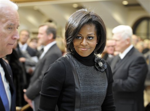 
 First lady Michelle Obama and Vice President Joe Biden, left, attend the funeral Mass for R. Sargent Shriver at Our Lady of Mercy Parish in Potomac, Md., on the outskirts of Washington Saturday, Jan. 22, 2011. Shriver, an in-law of the Kennedys, and the first director of the Peace Corps, died Tuesday. He was 95.(AP Photo/Cliff Owen/Pool)
 