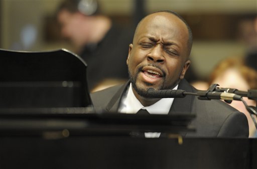 
 Singer Wyclef Jean performs 'Psalm 98' during the funeral Mass for R. Sargent Shriver at Our Lady of Mercy Parish in Potomac, Md., on the outskirts of Washington Saturday, Jan. 22, 2011. Shriver, an in-law of the Kennedys, and the first director of the Peace Corps, died Tuesday. He was 95. (AP Photo/Cliff Owen, Pool)
 