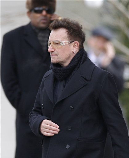 
 Rock singer Bono leaves following the funeral Mass for R. Sargent Shriver at Our Lady of Mercy Catholic church in Potomac, Md., just outside Washington, Saturday, Jan. 22, 2011. Shriver, the man responsible for launching the Peace Corps after marrying into the Kennedy family, died last Tuesday at age 95 after suffering from Alzheimer's disease for years. (AP Photo/J. Scott Applewhite)
 