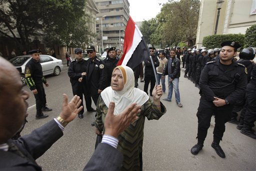 
 An angry Egyptian activist shouts in front of anti-riot policemen who block the way leading to journalists syndicate in downtown Cairo, Egypt, Wednesday, Jan. 26, 2011. A small gathering of Egyptian anti-government activists tried to stage a second day of protests in Cairo Wednesday in defiance of a ban on any gatherings, but police quickly moved in and used force to disperse the group. (AP Photo/Ben Curtis)
 