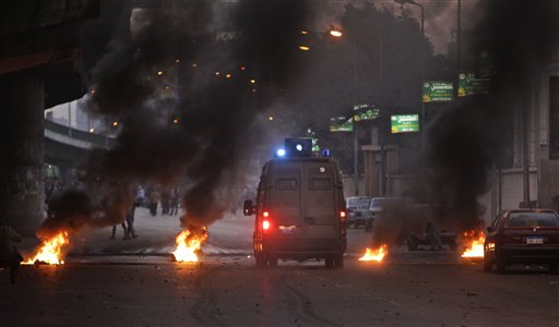 
 A riot van drives through a burning barricade as Egyptian riot police clash with anti-government activists in downtown Cairo, Egypt, Wednesday, Jan. 26, 2011. Egyptian anti-government activists clashed with police for a second day Wednesday in defiance of an official ban on any protests but beefed up police forces on the streets quickly moved in and used tear gas and beatings to disperse demonstrations. (AP Photo/Ben Curtis)
 