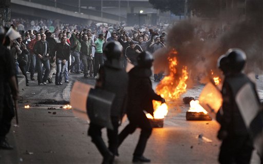 
 Egyptian riot police clash with anti-government activists in Cairo, Egypt, Wednesday, Jan. 26, 2011. Egyptian anti-government activists clashed with police for a second day Wednesday in defiance of an official ban on any protests but beefed up police forces on the streets quickly moved in and used tear gas and beatings to disperse demonstrations. (AP Photo/Ben Curtis)
 
