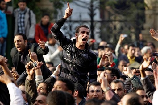 
 Angry Egyptian activist shouts at anti-riot policemen outside the journalists syndicate in downtown Cairo, Egypt, Wednesday, Jan. 26, 2011. A small gathering of Egyptian anti-government activists tried to stage a second day of protests in Cairo Wednesday in defiance of a ban on any gatherings, but police quickly moved in and used force to disperse the group. (AP Photo/Ben Curtis)
 