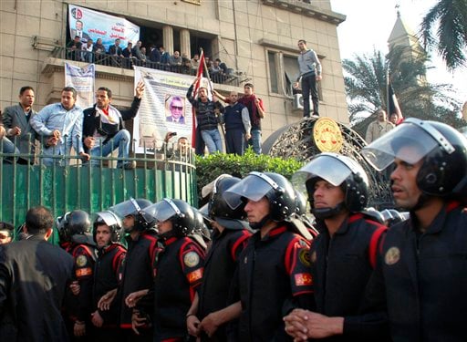 
 Egyptian anti-riot police block the way leading to a journalists syndicate in downtown Cairo, Egypt, Wednesday, Jan. 26, 2011. A small gathering of Egyptian anti-government activists tried to stage a second day of protests in Cairo Wednesday in defiance of a ban on any gatherings, but police quickly moved in and used force to disperse the group. (AP Photo/Mohammed Abu Zaid)
 