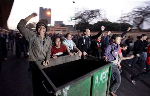 
 Anti-government activists wheel a rubbish bin to form a barricade as they clash with Egyptian riot police in downtown Cairo, Egypt, Wednesday, Jan. 26, 2011. Egyptian anti-government activists clashed with police for a second day Wednesday in defiance of an official ban on any protests but beefed up police forces on the streets quickly moved in and used tear gas and beatings to disperse demonstrations. (AP Photo/Ben Curtis)
 