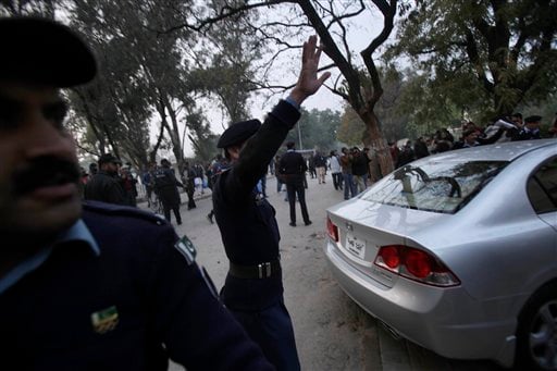 
 Pakistani police officers ask the crowd to leave the site where Punjab Gov. Salman Taseer was shot dead by one of his guards, in Islamabad, Pakistan, Tuesday, Jan. 4, 2011. The governor of Pakistan's powerful Punjab province was shot dead Tuesday by one of his guards in the Pakistani capital, police said, the killing was the most high-profile assassination of a political figure in Pakistan since the slaying of former Prime Minister Benazir Bhutto in December of 2007. (AP Photo/Muhammed Muheisen)
 