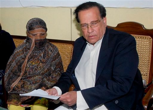 
 FILE - In this Nov. 20, 2010 file photo, Salman Taseer, right, Governor of Pakistani Punjab Province, listens to Pakistani Christian woman Asia Bibi, left, at a prison in Sheikhupura near Lahore, Pakistan. Taseer was shot dead Tuesday, Jan. 4, 2011, by one of his guards in the Pakistani capital, apparently because he had spoken out against the country's controversial blasphemy laws, officials said. The killing of Taseer was the most high-profile assassination of a political figure in Pakistan since the slaying of former Prime Minister Benazir Bhutto in December 2007, and it rattled a country already dealing with crises ranging from a potential collapse of the government to Islamist militancy. (AP Photo/File)
 