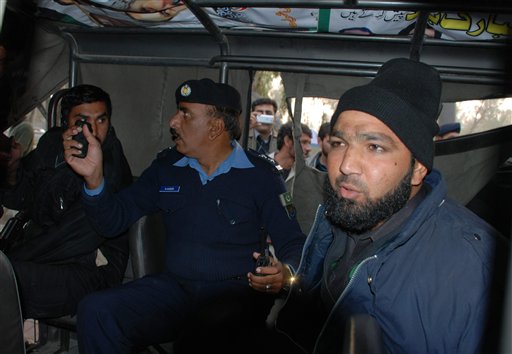 
 Commando of Pakistan's Elite force Mumtaz Qadri, right, who allegedly killed Punjab's governor Salman Taseer sits in a police custody in Islamabad, Pakistan on Tuesday, Jan. 4, 2011. An intelligence official interrogating the suspect, identified as Mumtaz Qadri, told The Associated Press that the bearded elite force police commando was boasting about the assassination, saying he was proud to have killed a blasphemer. The governor of Pakistan's powerful Punjab province was shot dead Tuesday by one of his guards in the Pakistani capital, police said, the killing was the most high-profile assassination of a political figure in Pakistan since the slaying of former Prime Minister Benazir Bhutto in December of 2007. (AP Photo/Irfan Ali)
 