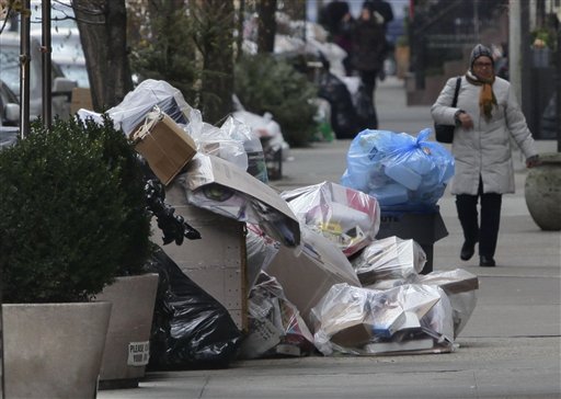 
 Uncollected garbage overflow onto a sidewalk on 53rd Street on Thursday, Jan. 6, 2011, in mid-Manhattan area of New York. Another storm is being forecast for New York City, where Mayor Michael Bloomberg is still under fire for slow cleanup of last week's blizzard that kept streets clogged for days and delayed trash pickups. (AP Photo/Bebeto Matthews)
 