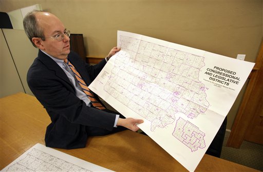 
 Ed Cook, legal counsel for the Iowa Legislative Services Agency, holds a map of Iowa that will be used to help in drawing new congressional district lines, Wednesday, Feb. 9, 2011, in Des Moines, Iowa. The once-a-decade process of redistricting is a bare-knuckles display of politics as incumbents seek to protect their districts and parties scramble for any advantage - except in Iowa where three nonpartisan staffers redraw the lines, focused solely on making districts compact and equal in population. (AP Photo/Charlie Neibergall)
 